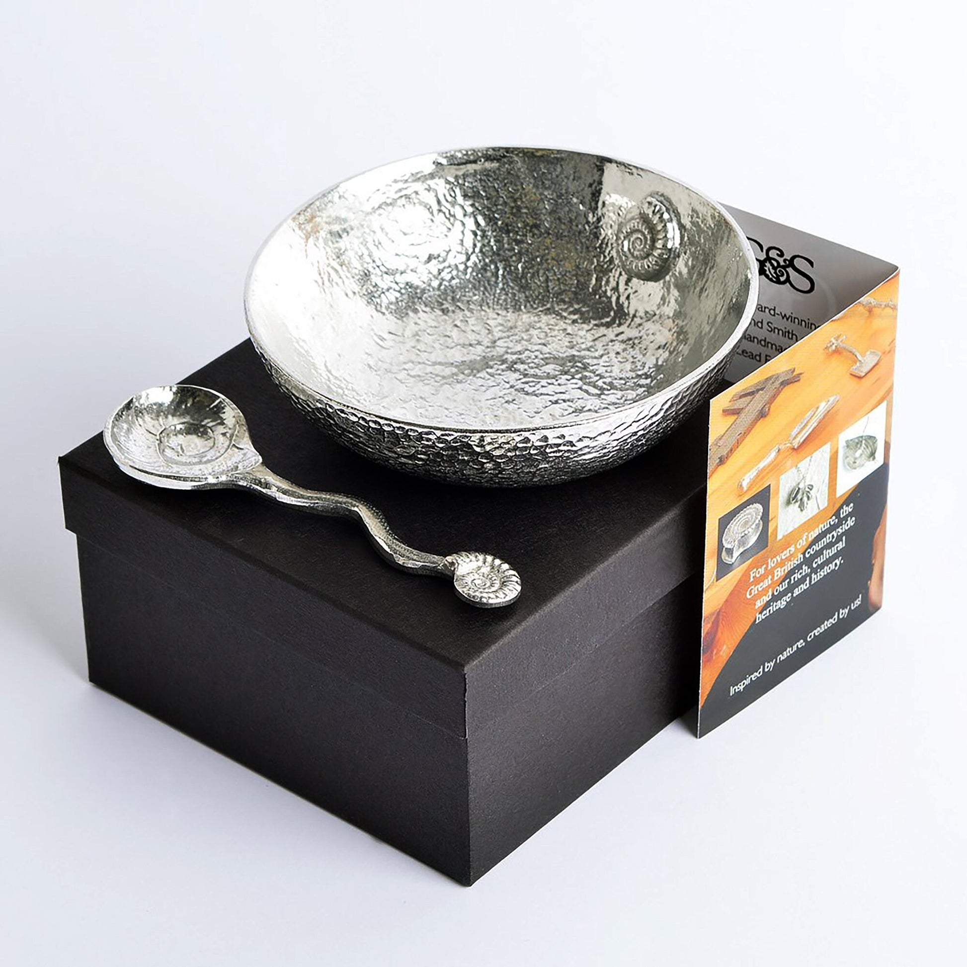 A 9cm diameter beautifully textured circular pewter bowl, with a striking, yet subtle ammonite fossil on the inside of the dish, comes with accompanying ammonite  fossil spoon. Gifts For Fossil Lovers