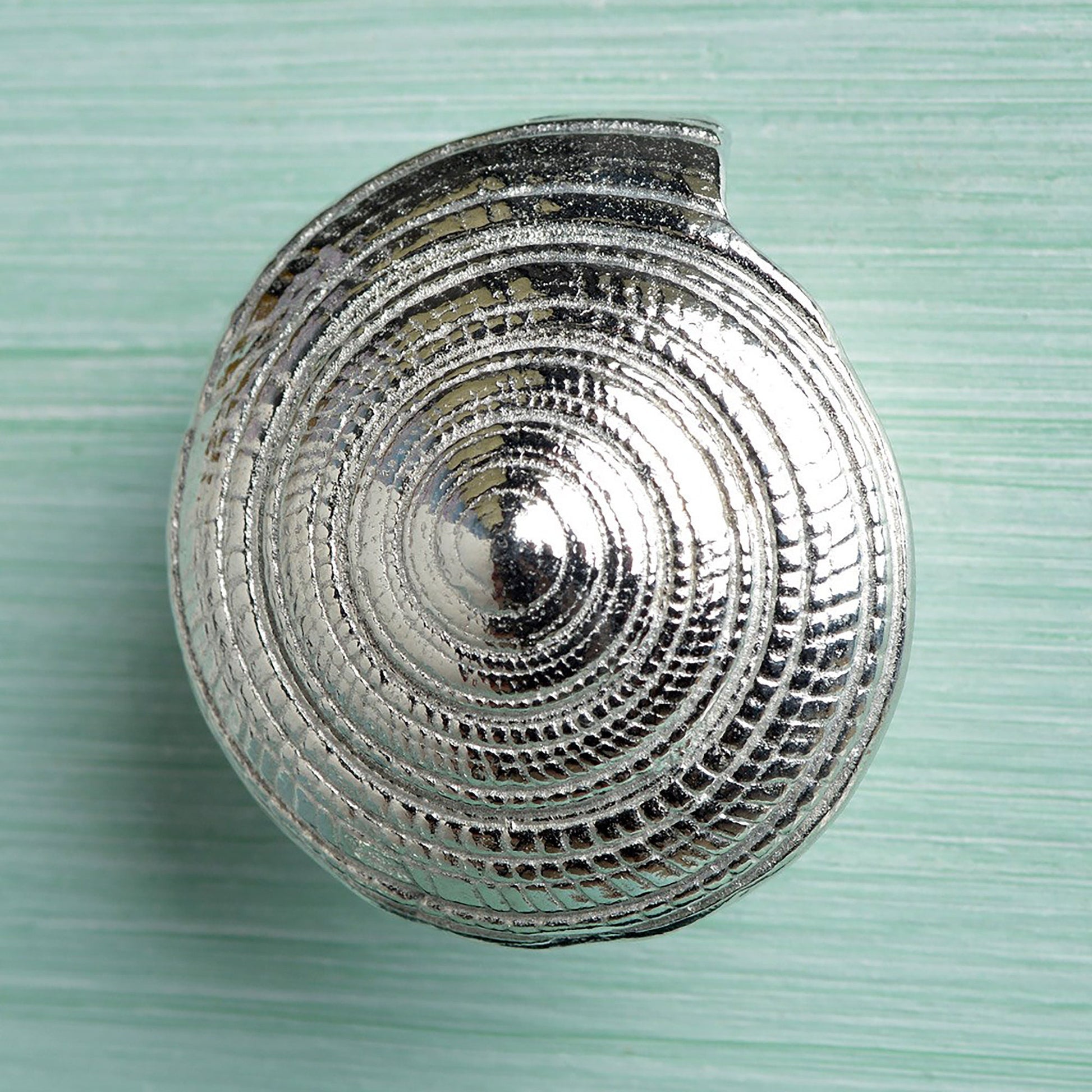 A solid pewter cabinet handle, cupboard knob, furniture handle or drawer pull in the shape of a detailed spiral sea shell. Organic, unusual handles UK handmade with finesse