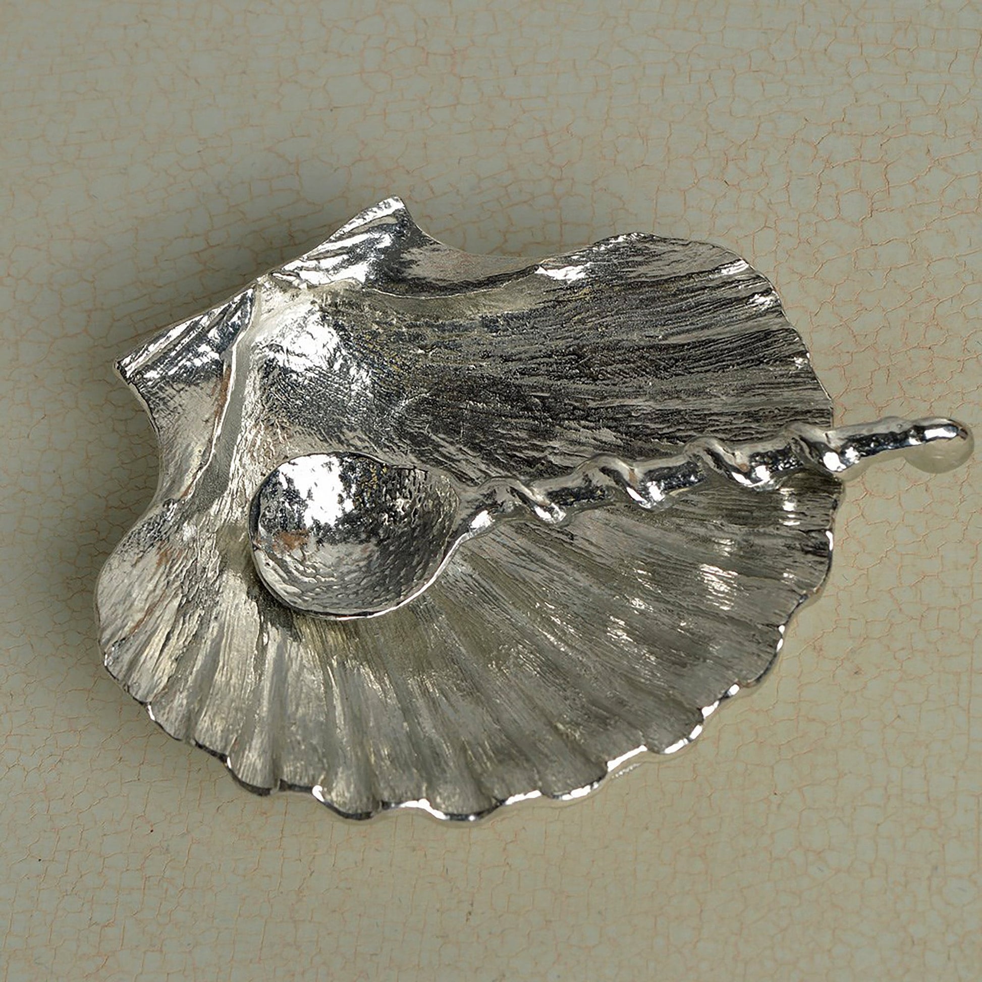 A detailed and textured pewter scallop shell bowl and spoon set. Ideal for salt, sugar, mustard etc. The accompanying spoon has a sea shell bowl and a small shell finial on an entwined handle. UK handmade.