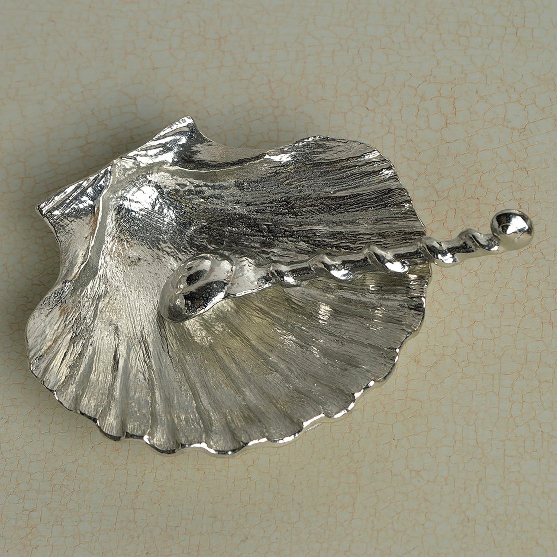 A detailed and textured pewter scallop shell bowl and spoon set. Ideal for salt, sugar, mustard etc. The accompanying spoon has a sea shell bowl and a small shell finial on an entwined handle. UK handmade.