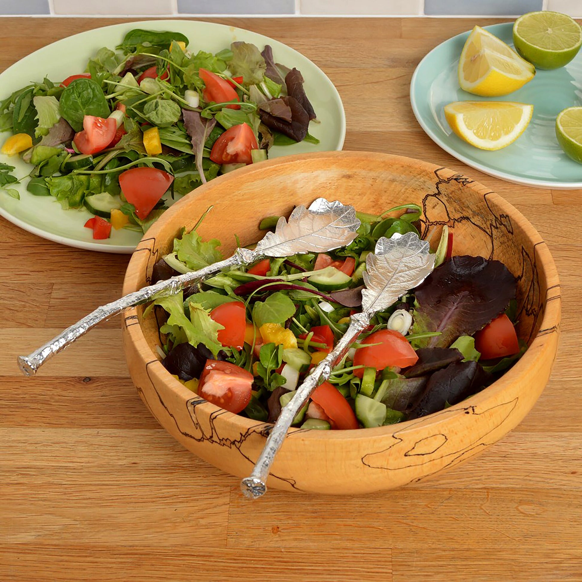 A pair of leaf design salad servers with oak leaf spoons on detailed twig textured handles. Pewter serving spoons handmade in the UK. A perfect 10th (Tin) ten year wedding anniversary gift (Our pewter is 95% tin).