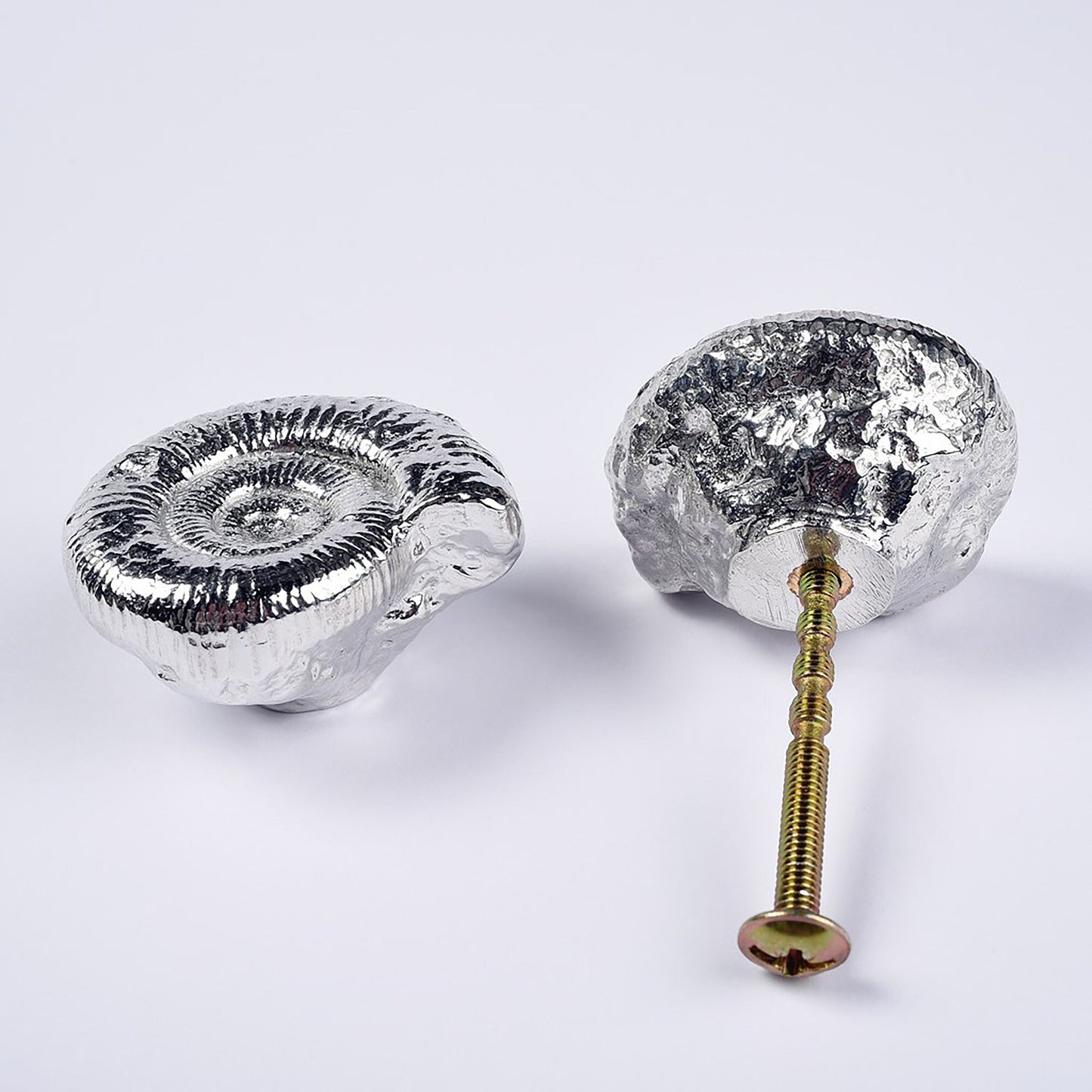 A solid pewter cabinet handle, cupboard knob, furniture handle or drawer pull in the shape of a detailed ammonite fossil. Organic, unusual handles UK handmade with finesse