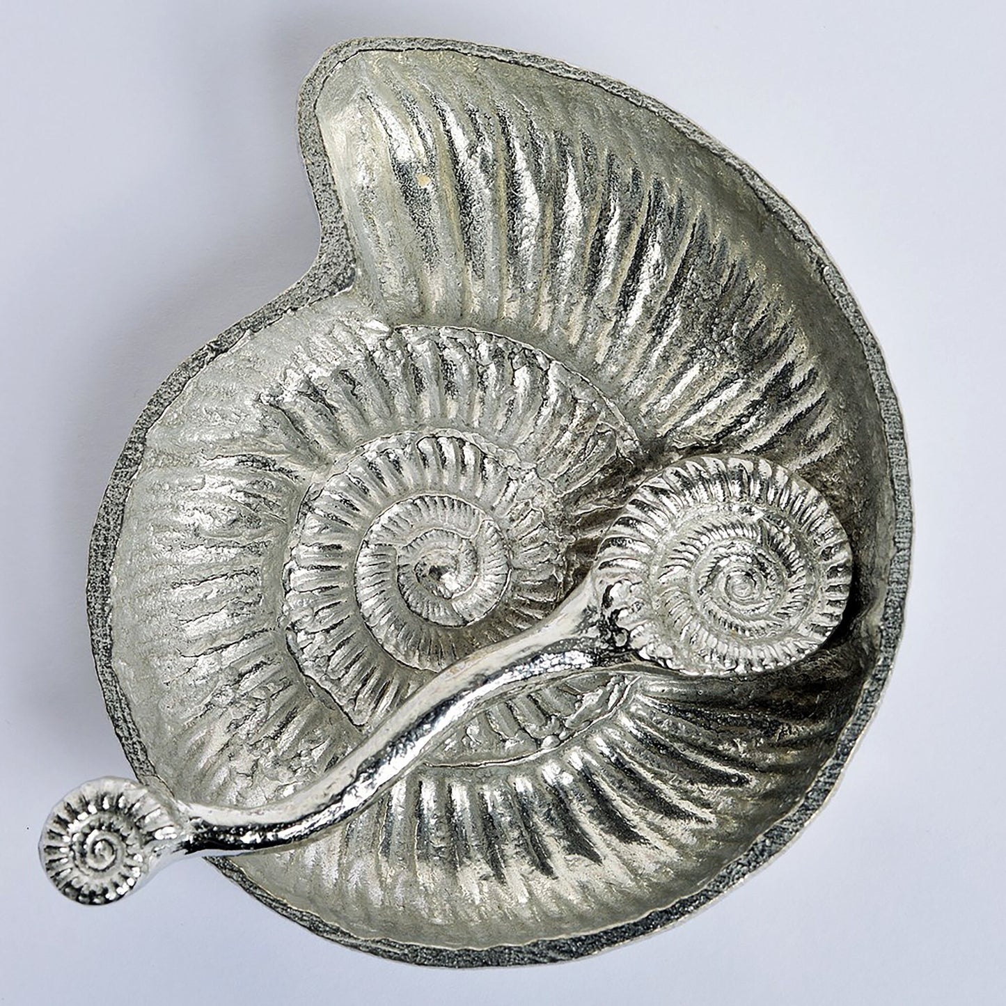 Ammonite fossil pewter bowl and spoon set. The ammonite bowl is cast from a real ammonite found on the Dorset coast. The accompanying spoon has an ammonite bowl and a smaller fossil on the end of a curved handle. UK handmade.