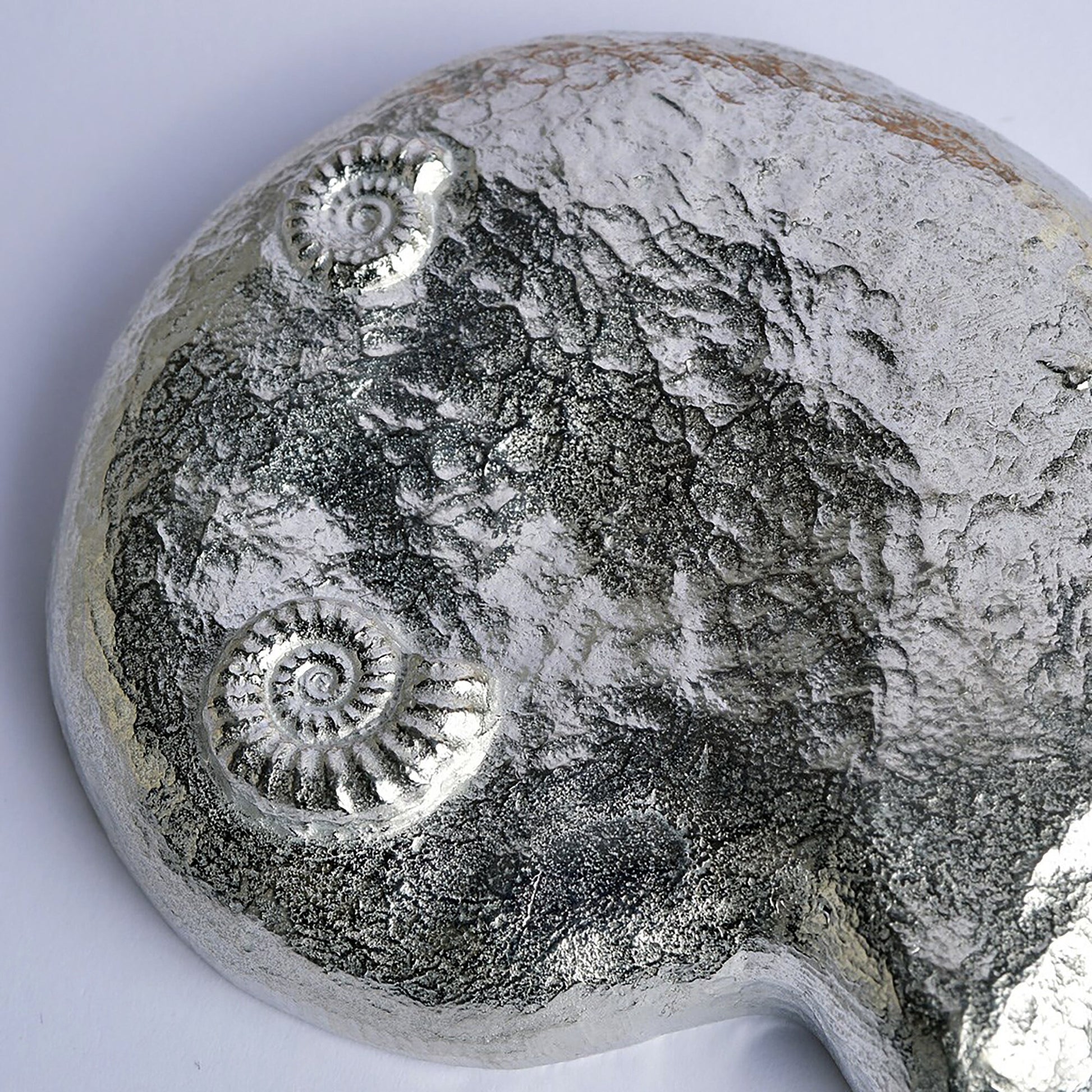 Ammonite fossil pewter bowl and spoon set. The ammonite bowl is cast from a real ammonite found on the Dorset coast. The accompanying spoon has an ammonite bowl and a smaller fossil on the end of a curved handle. UK handmade.