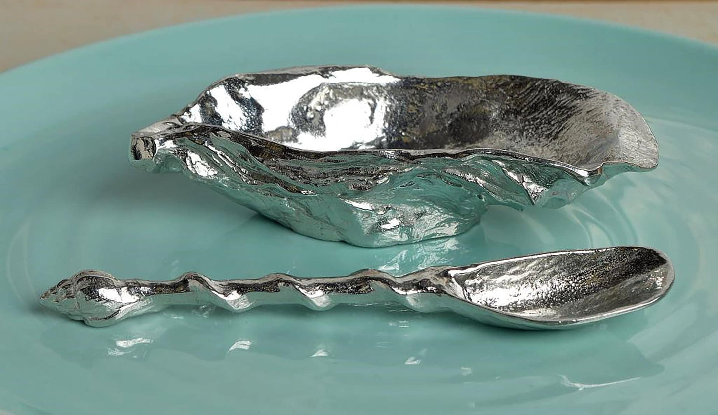 A beautifully detailed pewter oyster shell shaped bowl and mussel spoon set. The silver coloured oyster bowl is ideal for sea salt, sugar, mustard etc. The accompanying spoon has a mussel shell bowl and a small shell finial on an entwining stem.