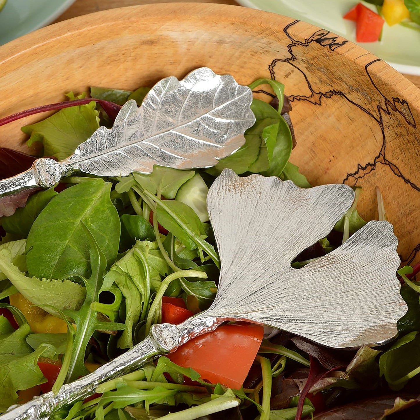 A pair of leaf design salad servers with ginkgo leaf and oak leaf spoons on detailed twig textured handles. Pewter serving spoons handmade in the UK. A perfect 10th (Tin) ten year wedding anniversary gift (Our pewter is 95% tin). UK handmade