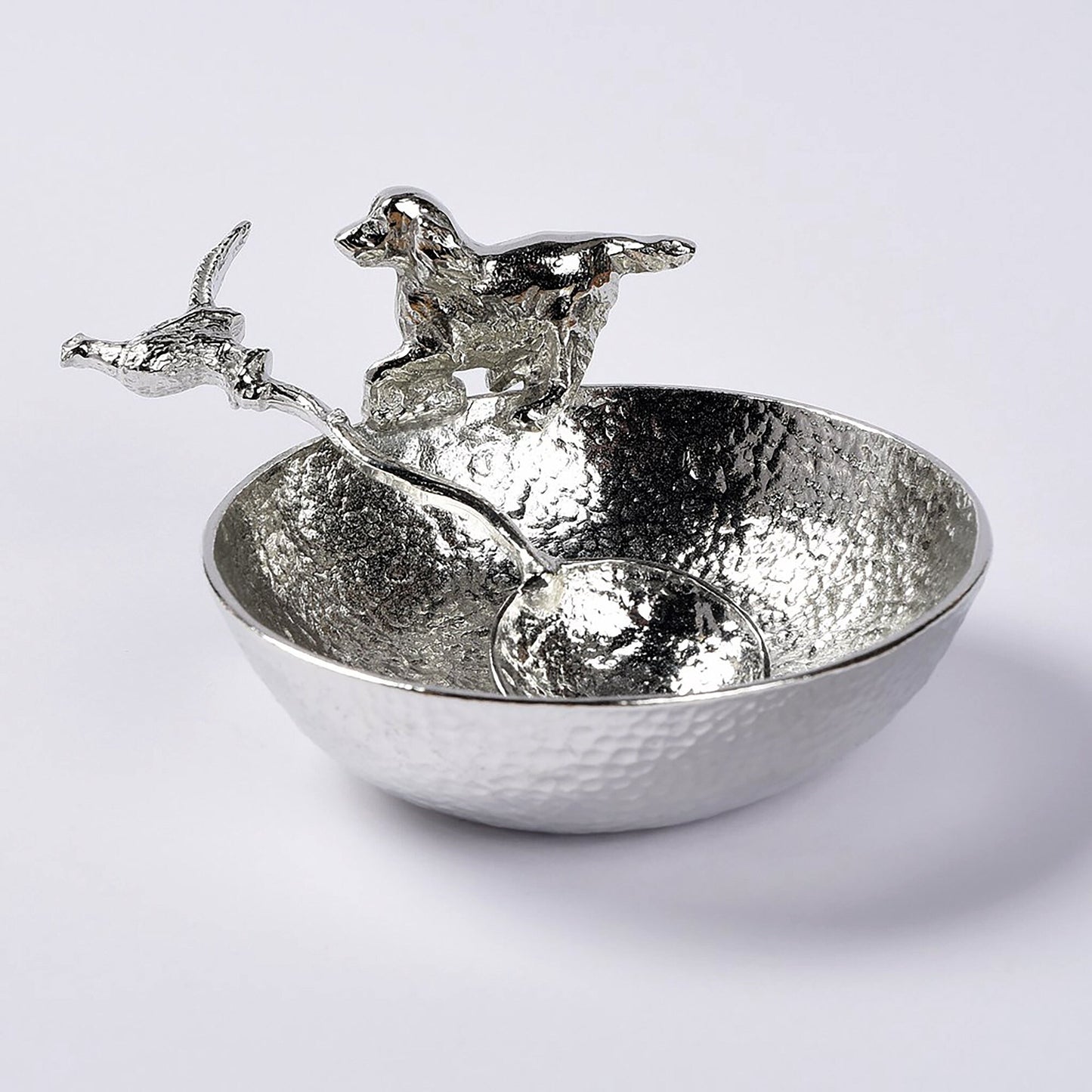 A 9cm diameter textured circular pewter bowl, with a springer spaniel bounding around the edge of the bowl, comes with accompanying pheasant spoon. Great spaniel gifts. Dog Lover Gifts, country gifts UK handmade.