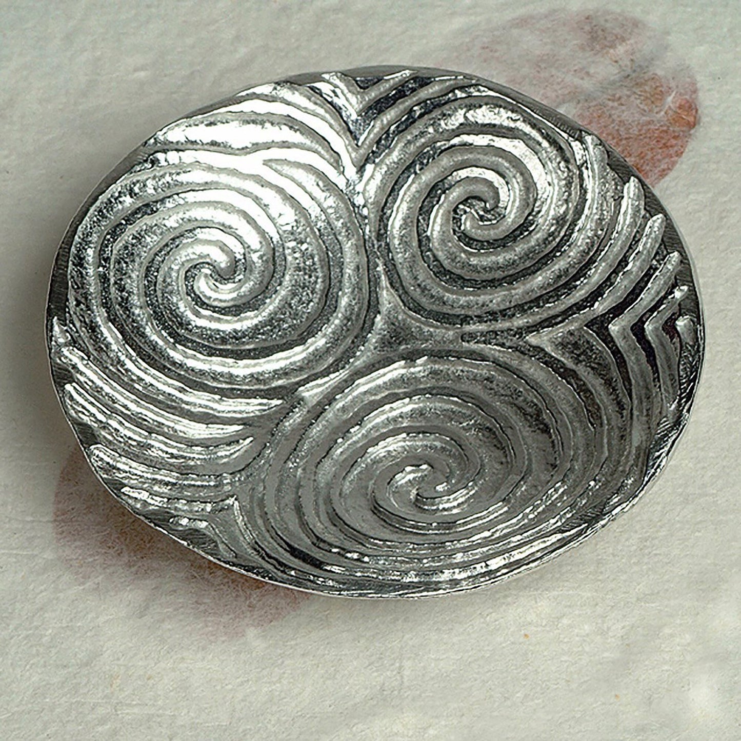 Spiral of life pewter trinket dish. Its design is based on the the triple spiral (or triskele) often called the Spiral of Life as found carved on the entrance stone at Newgrange in Ireland. Celtic spiral gifts.