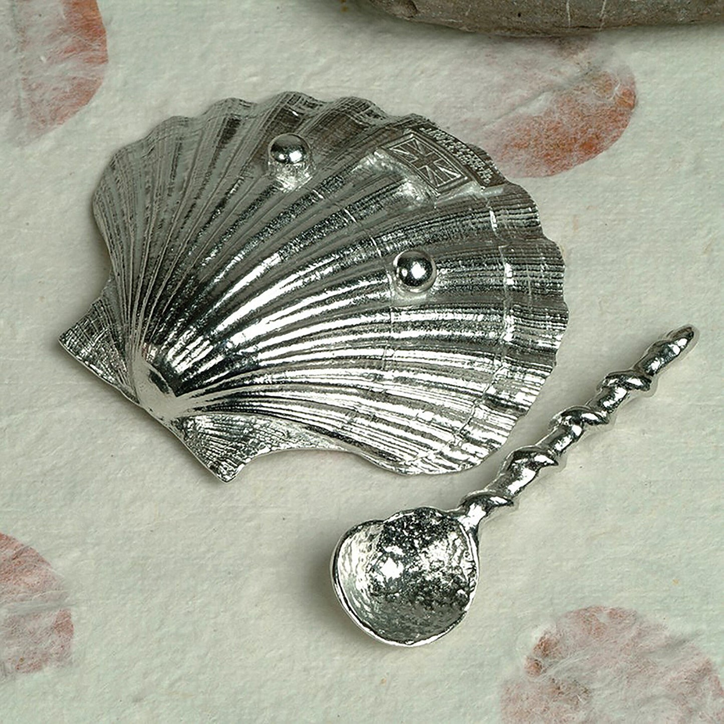 A detailed and textured pewter scallop shell bowl and spoon set. Ideal for salt, sugar, mustard etc. The accompanying spoon has a sea shell bowl and a small shell finial on an entwined handle. UK handmade.