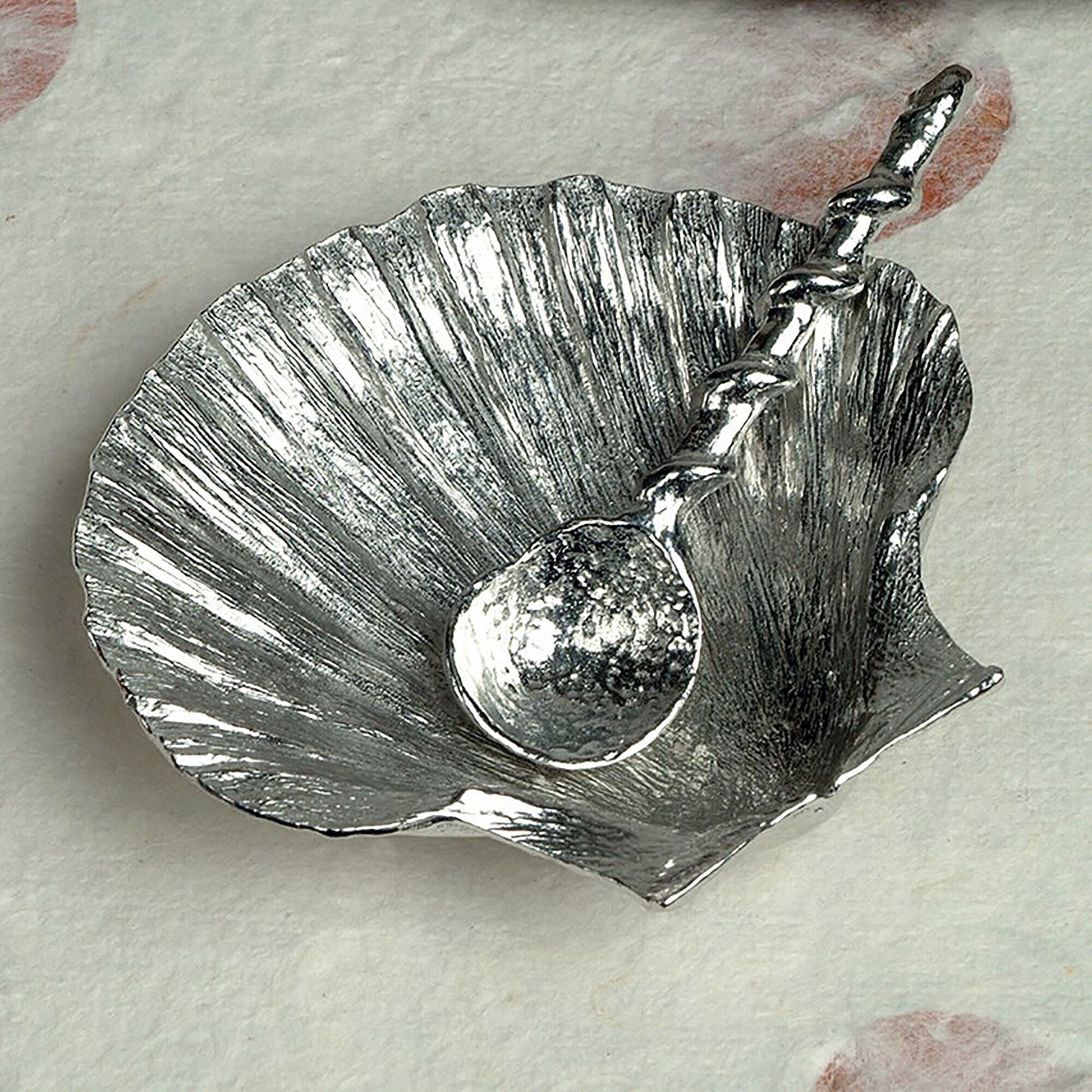 A detailed and textured pewter scallop shell bowl and spoon set. Ideal for salt, sugar, mustard etc. The accompanying spoon has a sea shell bowl and a small shell finial on an entwined handle. UK handmade.