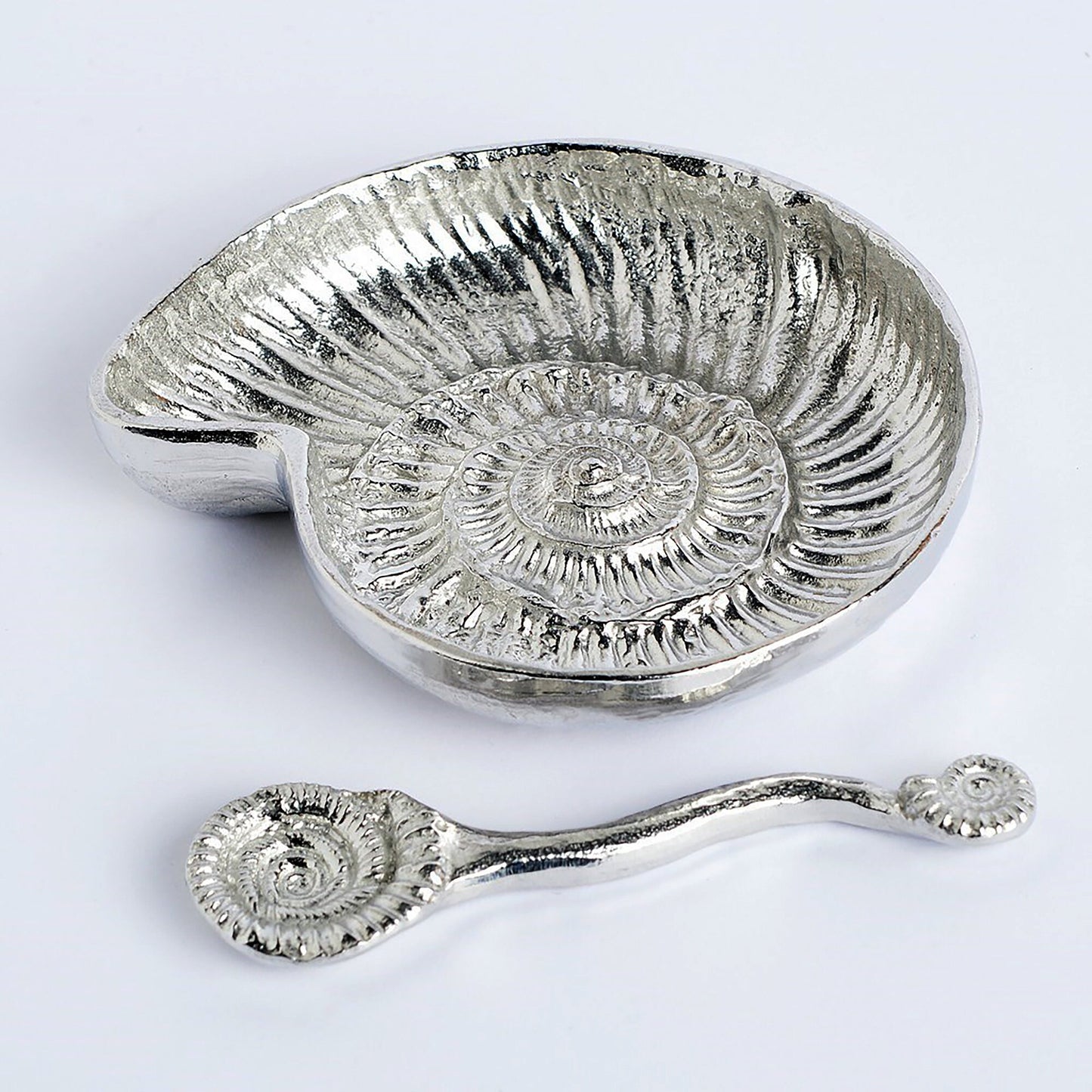 Ammonite fossil pewter bowl and spoon set. The ammonite bowl is cast from a real ammonite found on the Dorset coast. The accompanying spoon has an ammonite bowl and a smaller fossil on the end of a curved handle. UK handmade.