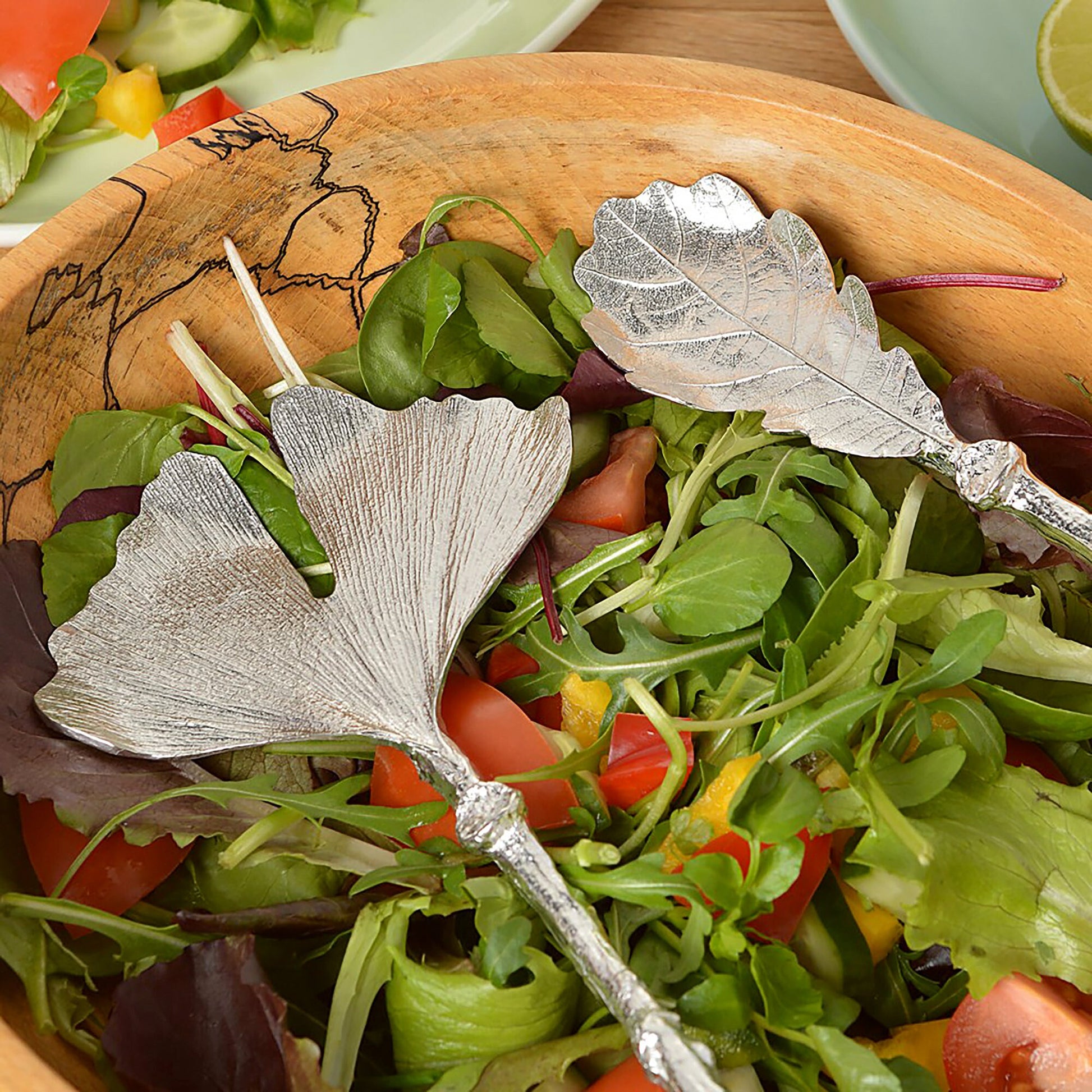 A pair of leaf design salad servers with ginkgo leaf and oak leaf spoons on detailed twig textured handles. Pewter serving spoons handmade in the UK. A perfect 10th (Tin) ten year wedding anniversary gift (Our pewter is 95% tin). UK handmade