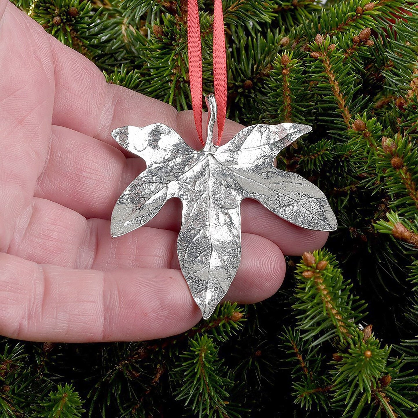 Our beautifully textured & detailed pewter Ivy leaf hangs from a red ribbon providing a gorgeous hanging Christmas tree decoration gifts. Pewter Christmas tree decorations, unusual Christmas decorations made in Britain